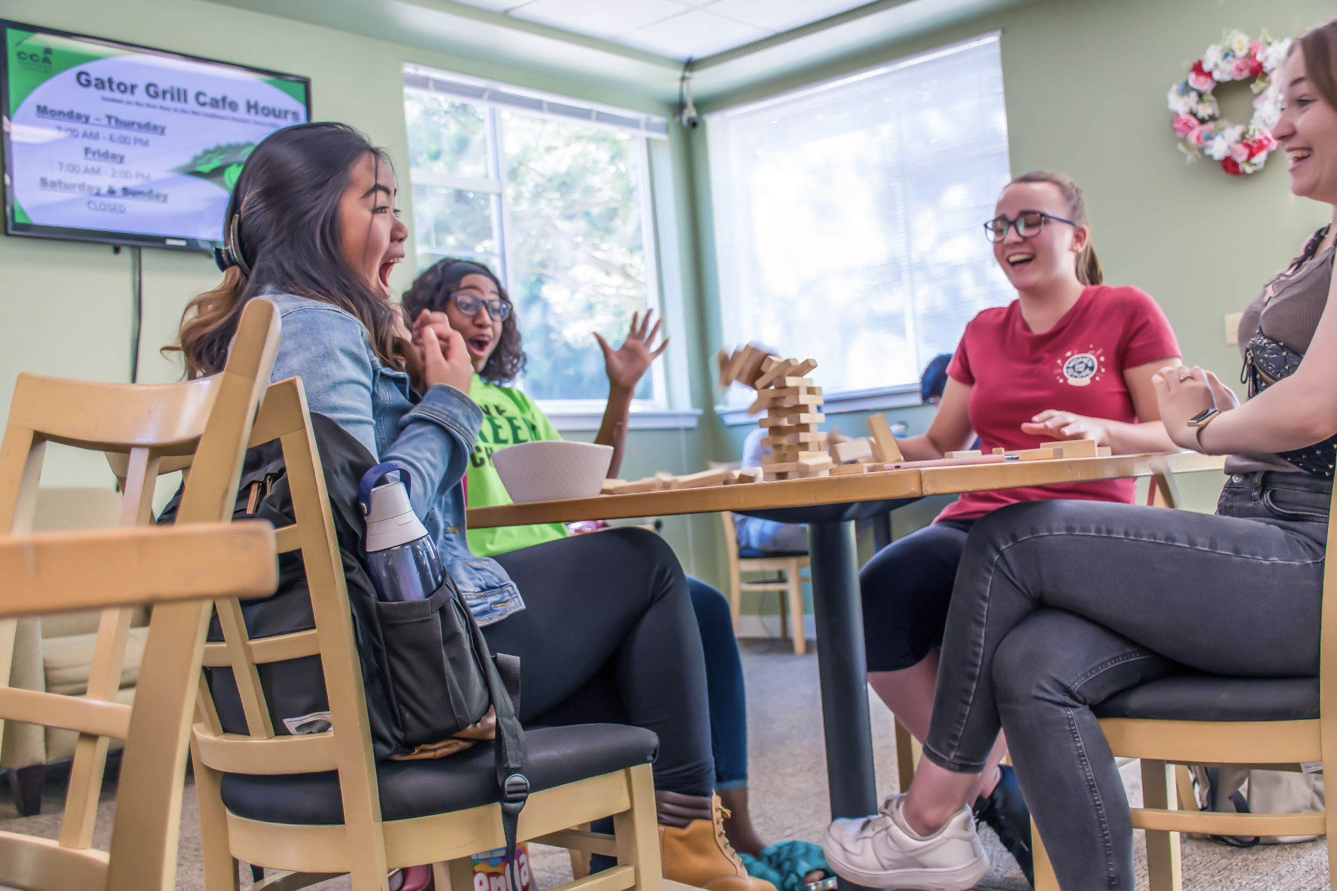 People siting around a table playing a game