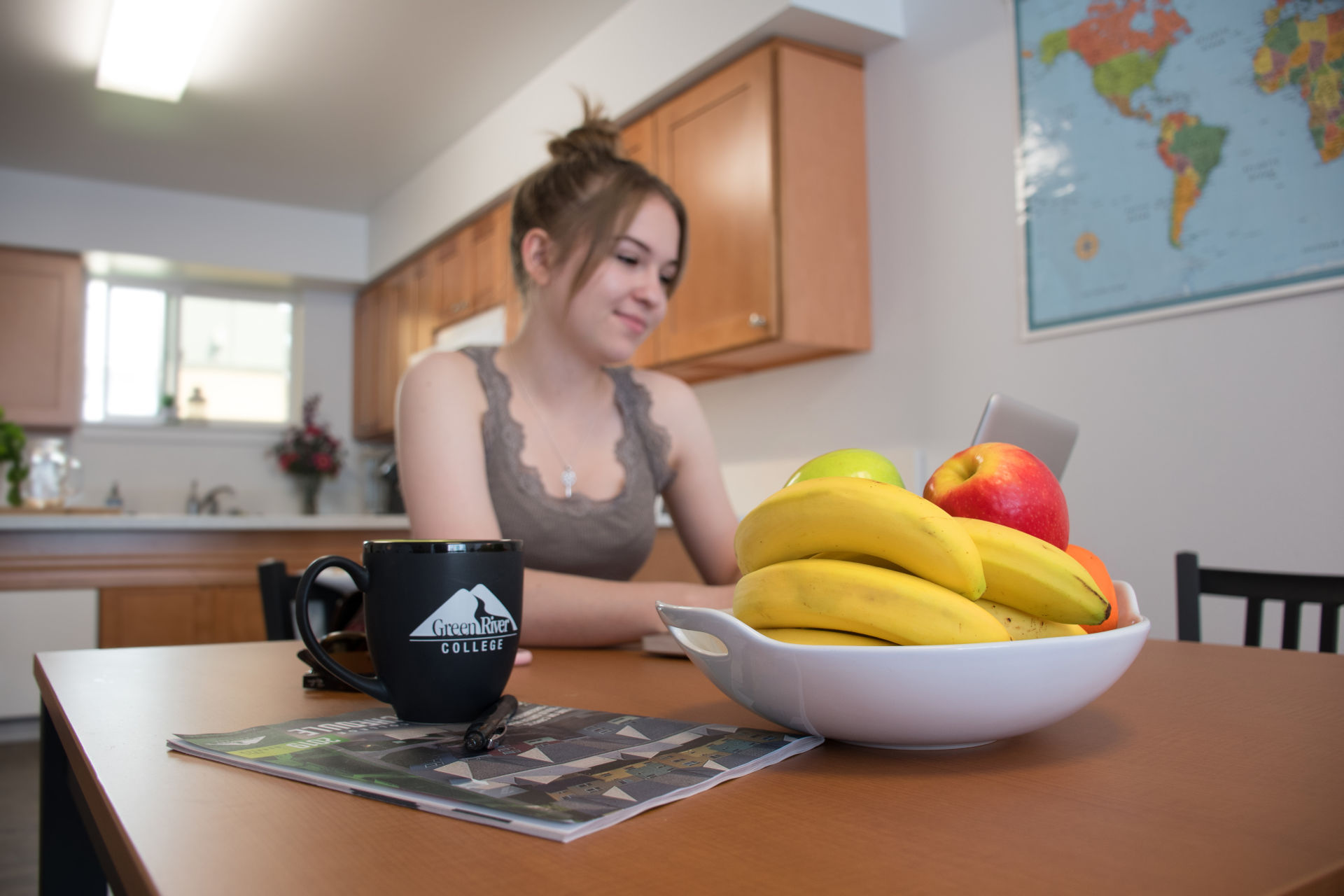 A person sitting at a table inside a Campus Corner Apartments unit