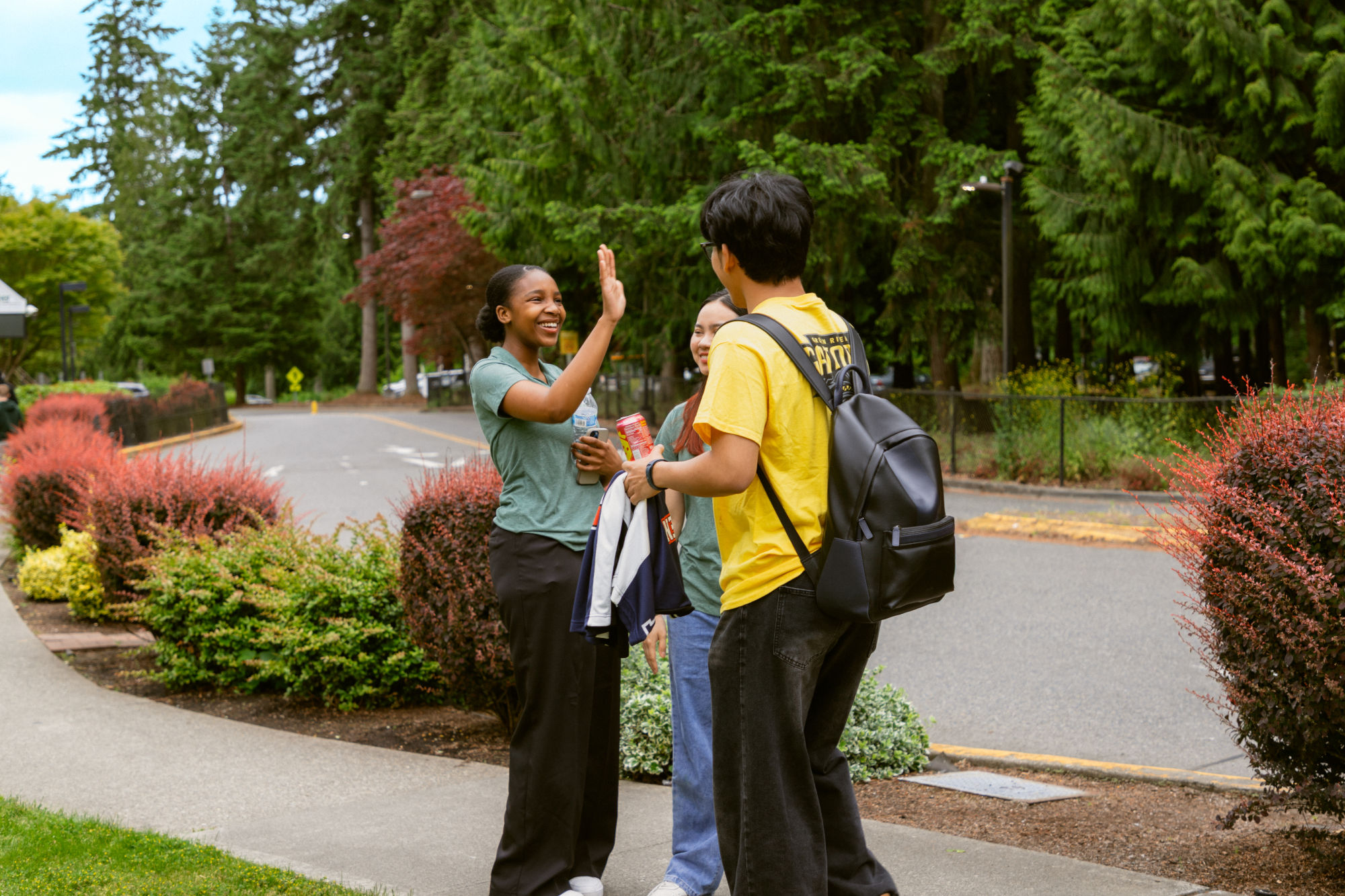 Students standing in front of the Campus Corner Apartments