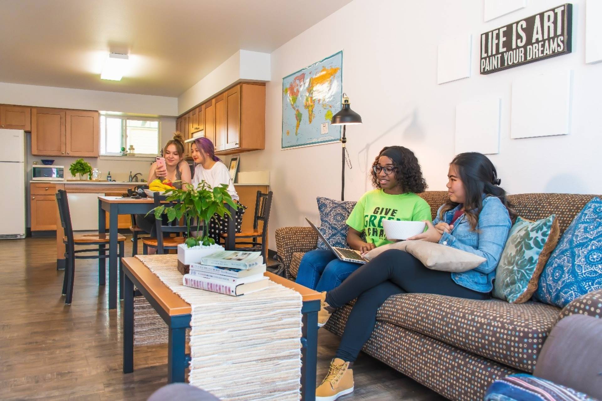 four students relaxing in a student housing apartment 