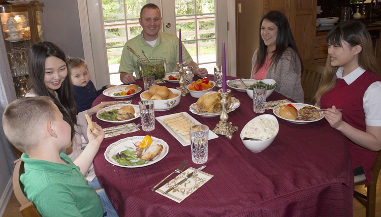 International students enjoy a dinner with their host family.