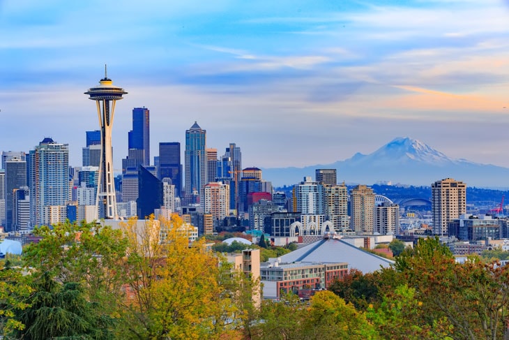 photo showing buildings of the city of Seattle with Mount Rainier in the background