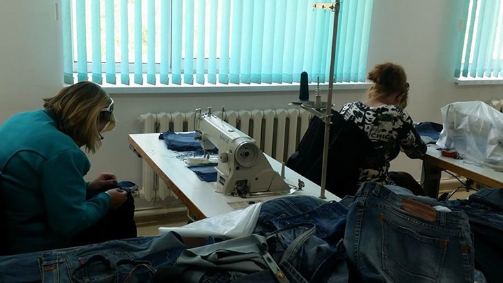 Women working at sewing tables.