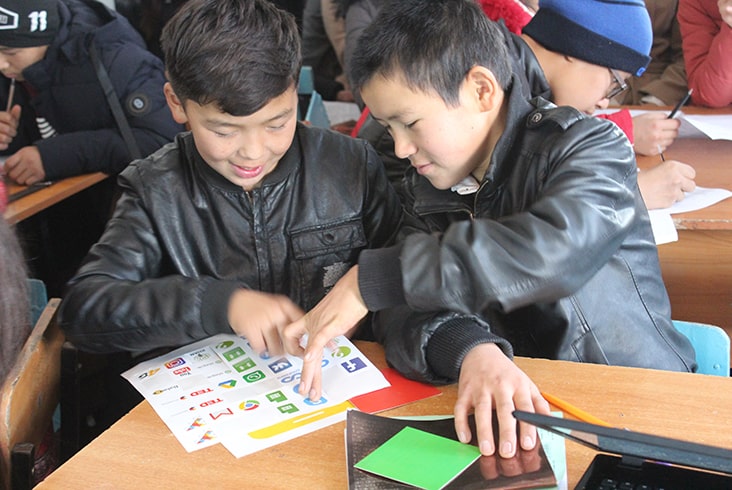 Two male students learning about smart phone applications.