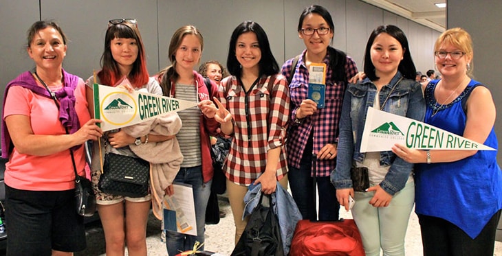 Green River College staff meeting students at airport