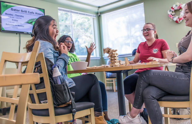 Green River College students playing jenga in a campus common area