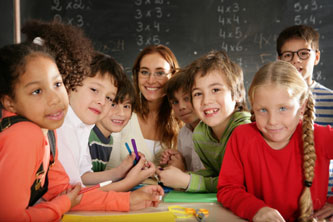 Divers class of young children surrounding teacher