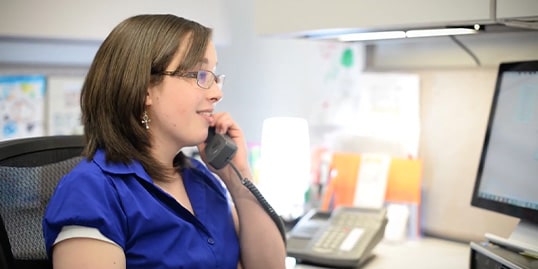 woman on phone at desk