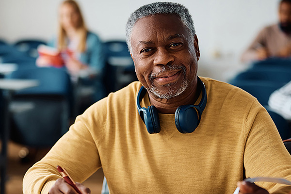 adult man in class wearing black headphones