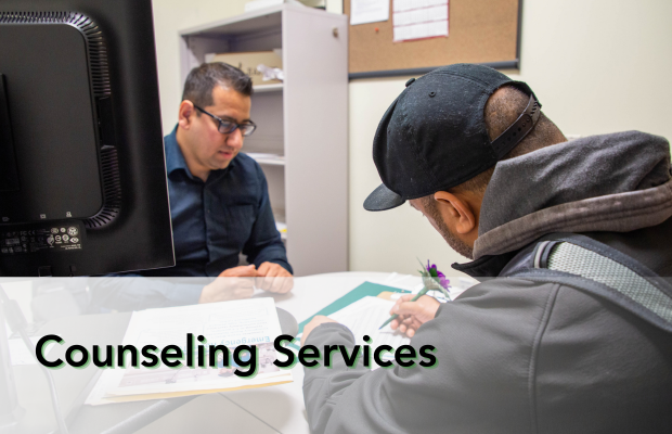 student sits with counselor doing paperwork